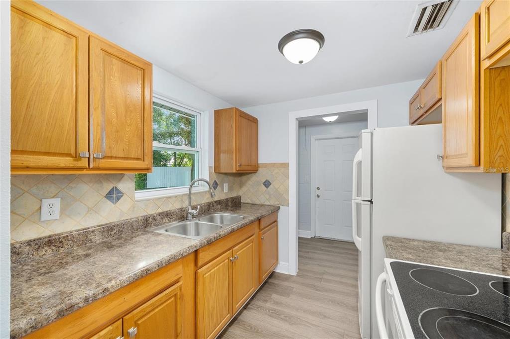 14761 Southwest 35th Terrace Road Ocala, FL 34473 - Photo 10 of 13 a kitchen with granite countertop a sink and a refrigerator
