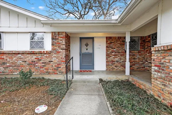 a view of front door of house with stairs