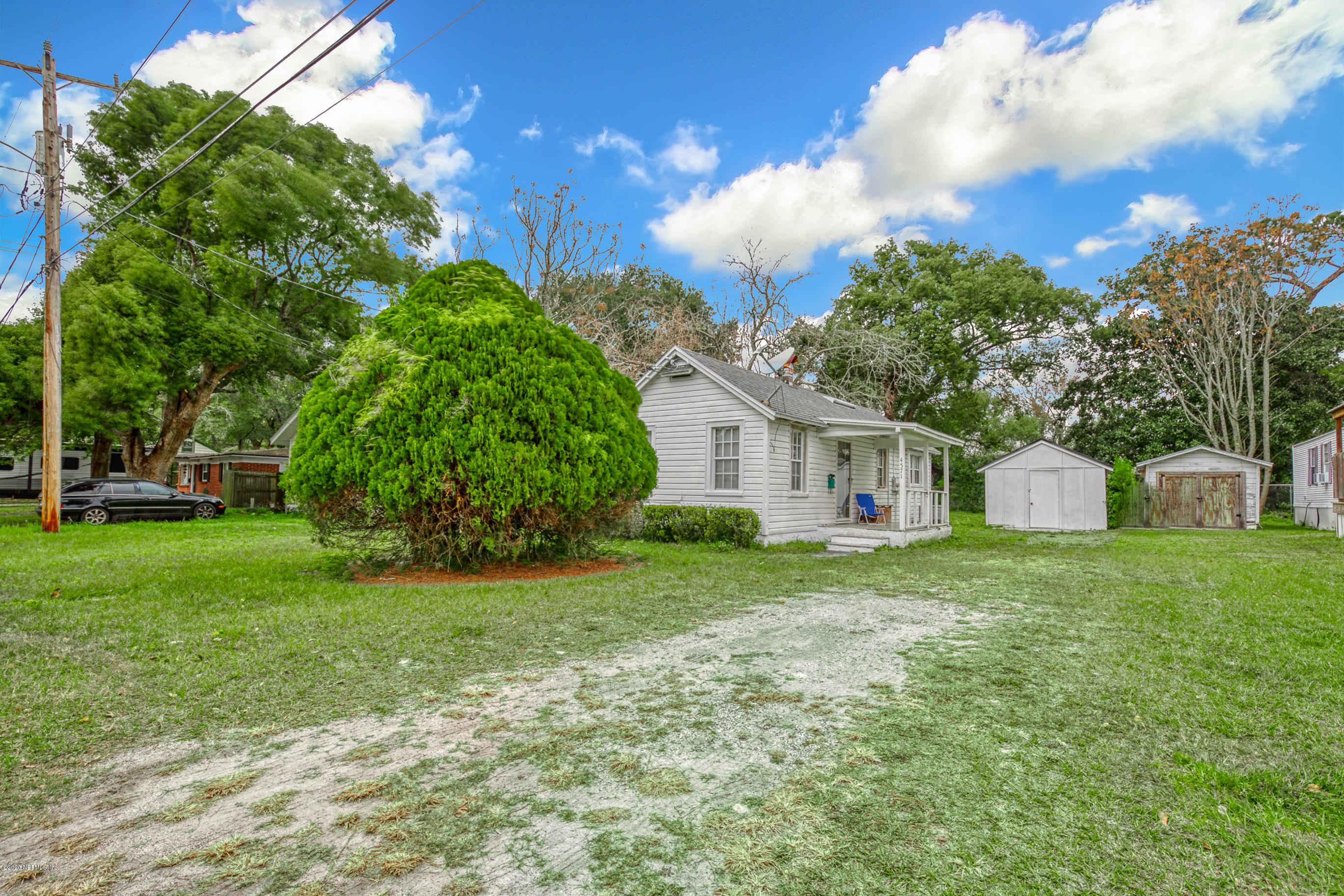 4571 Appleton Avenue Jacksonville, FL 32210 - Photo 1 of 30 a front view of a house with a yard and trees
