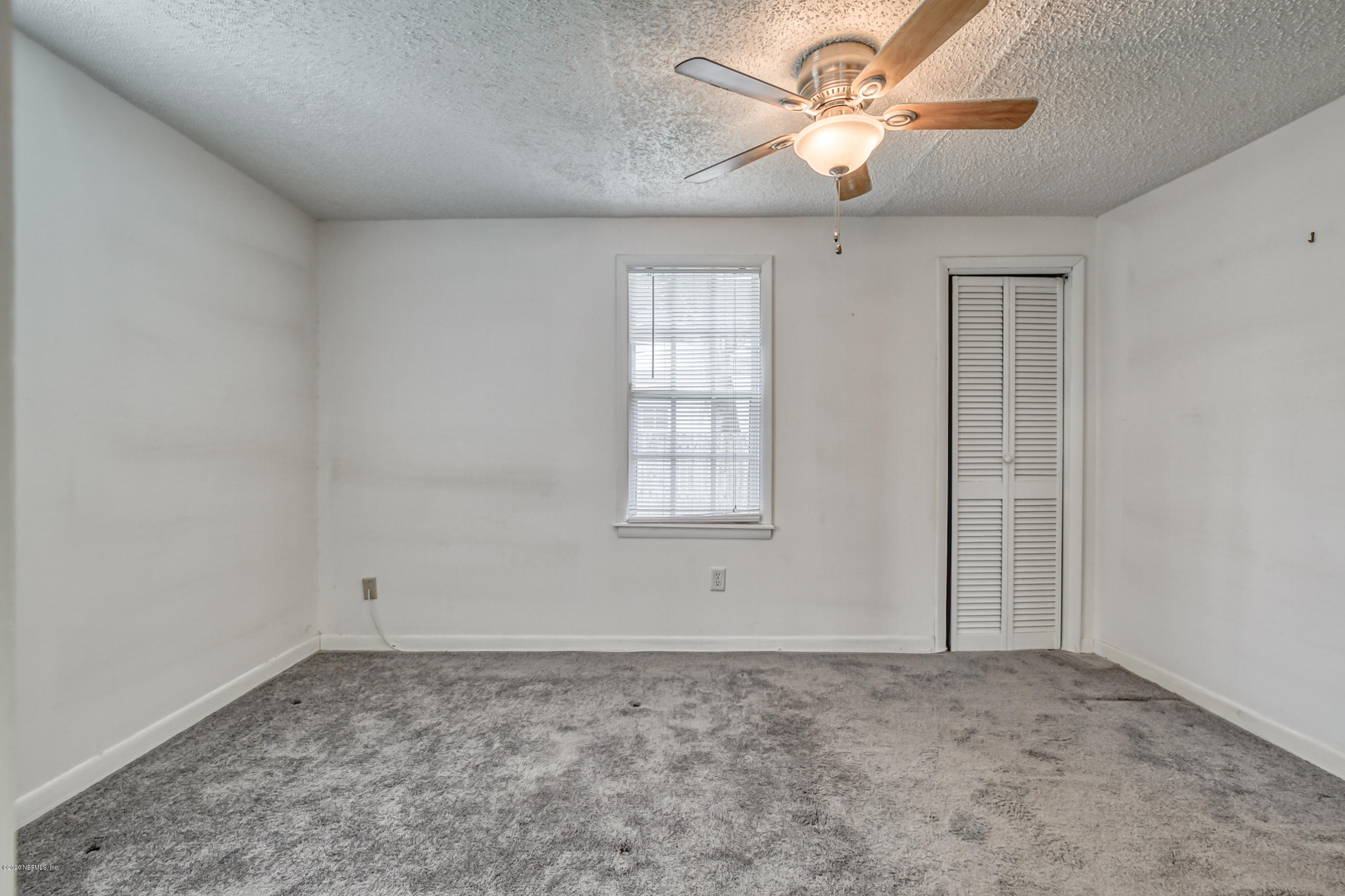 4571 Appleton Avenue Jacksonville, FL 32210 - Photo 12 of 30 a view of a livingroom with a ceiling fan and window