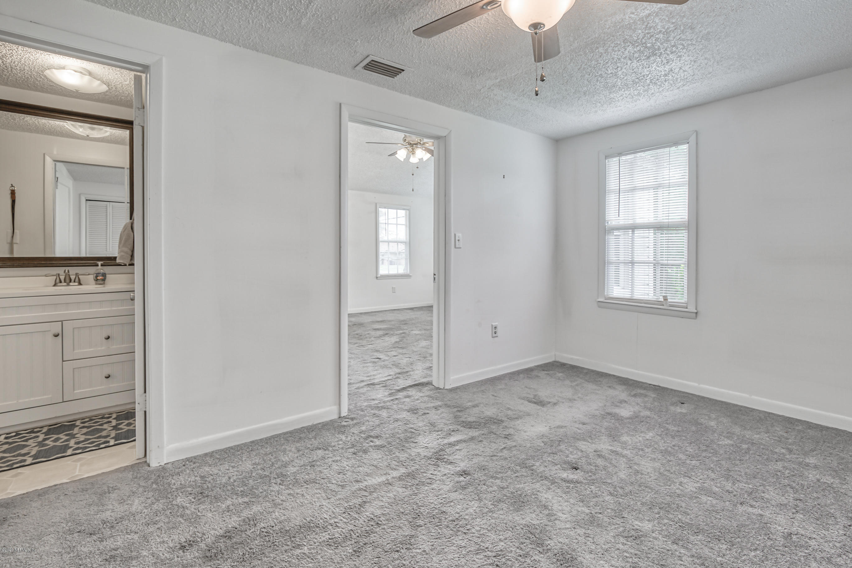 4571 Appleton Avenue Jacksonville, FL 32210 - Photo 14 of 30 an empty room with windows and cabinet