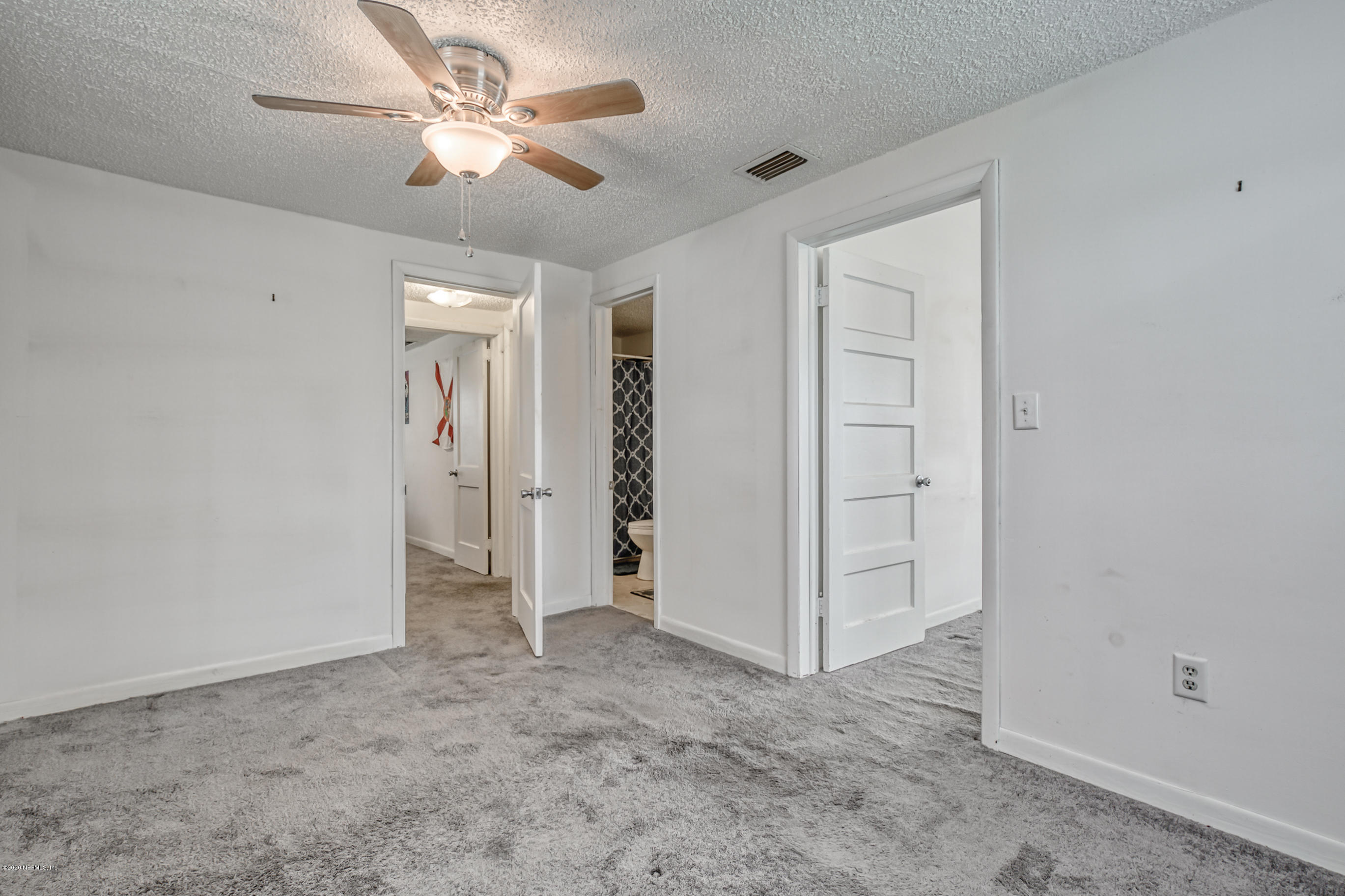 4571 Appleton Avenue Jacksonville, FL 32210 - Photo 15 of 30 an empty room with closet and a ceiling fan