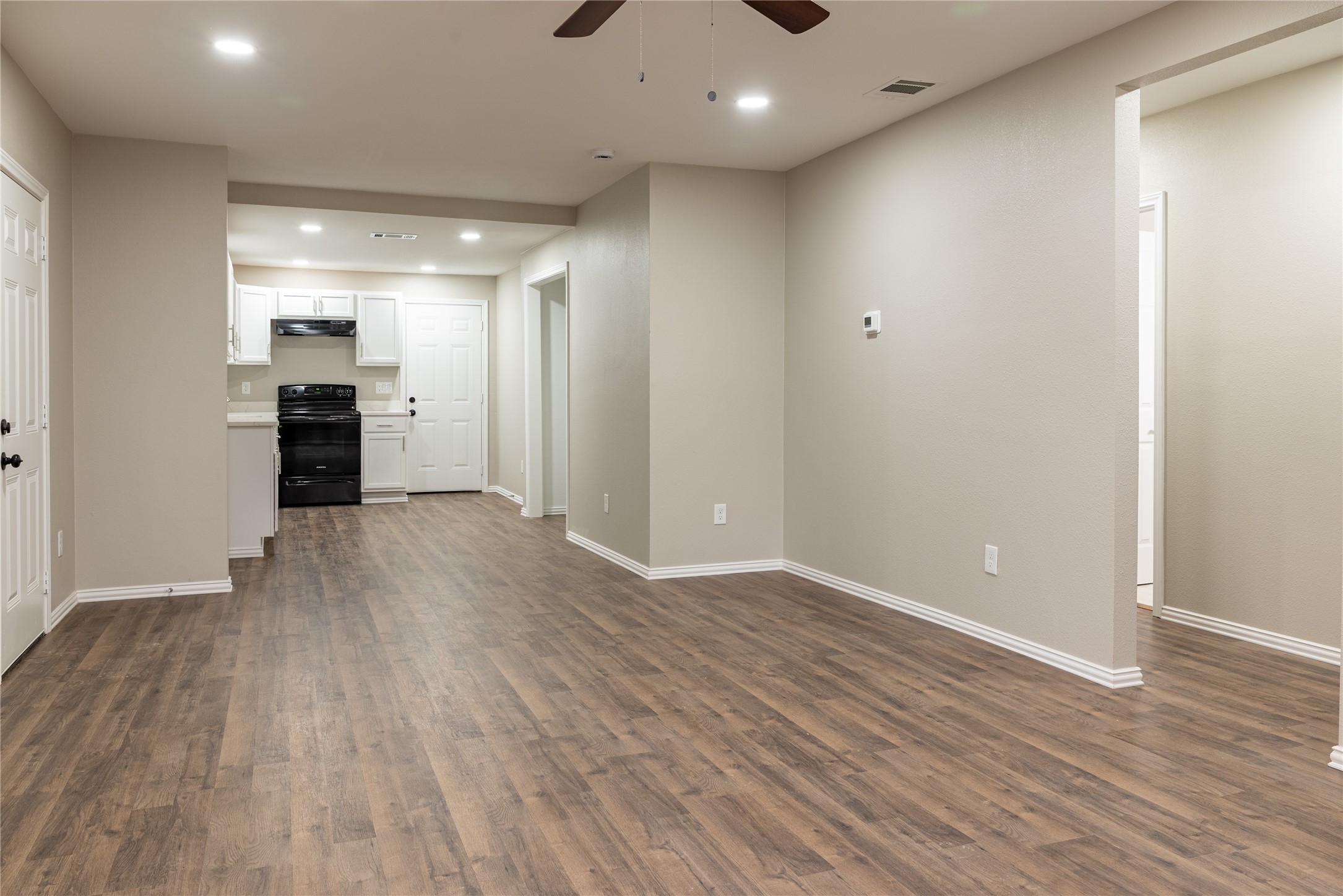 729 Planters Street Emory, TX 75440 - Photo 3 of 22 wooden floor in an empty room with a window