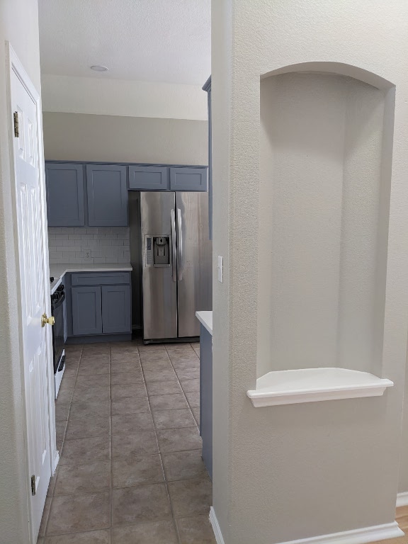 a view of a kitchen with refrigerator and cabinet