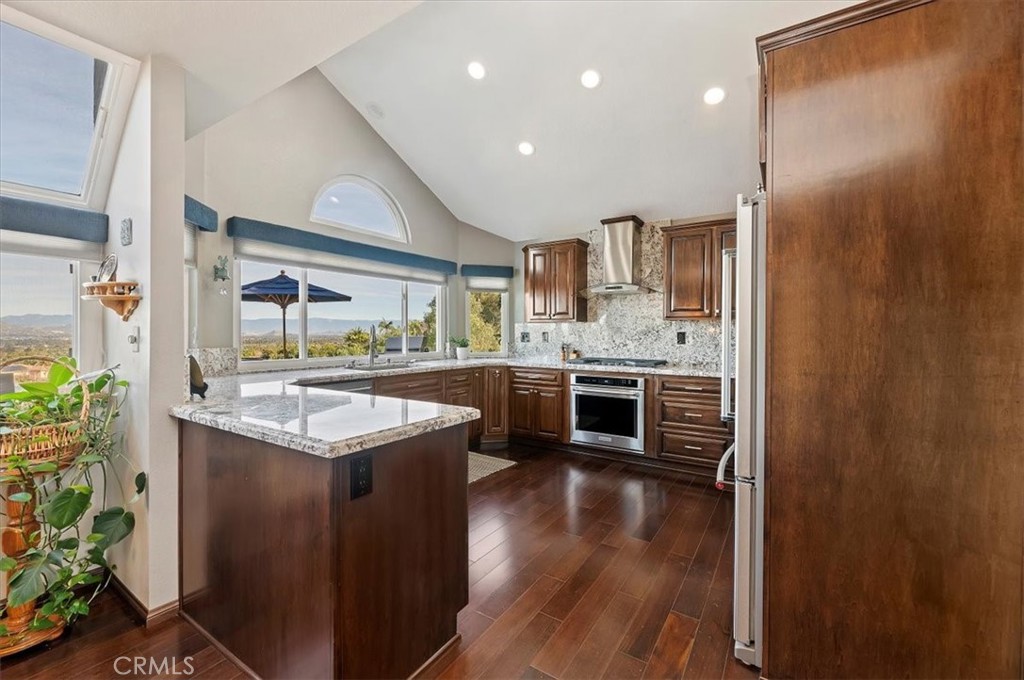 1793 Praed Street Riverside, CA 92503 - Photo 18 of 75 a kitchen with stainless steel appliances granite countertop a stove and a refrigerator