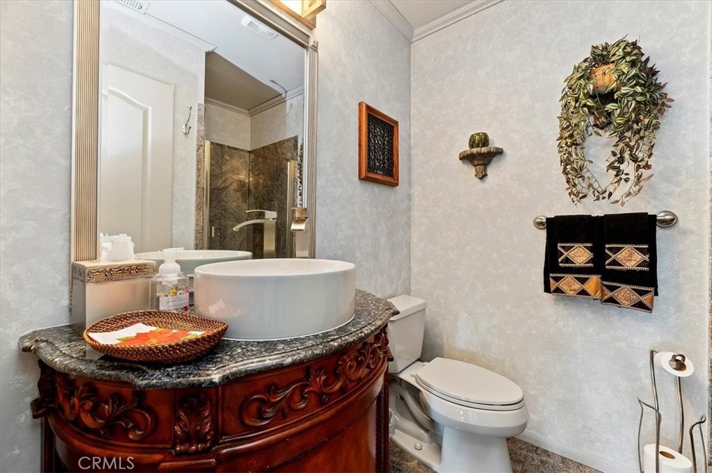 1793 Praed Street Riverside, CA 92503 - Photo 30 of 75 a bathroom with a toilet sink and mirror