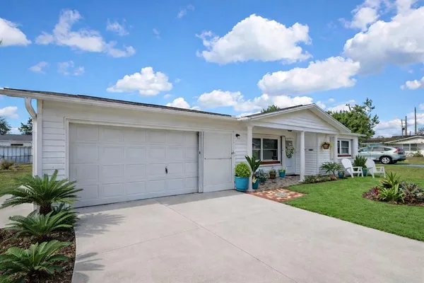 a front view of a house with garden and porch