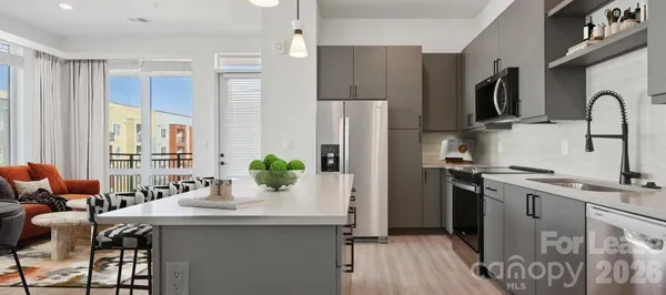 a kitchen with stainless steel appliances a sink stove and refrigerator