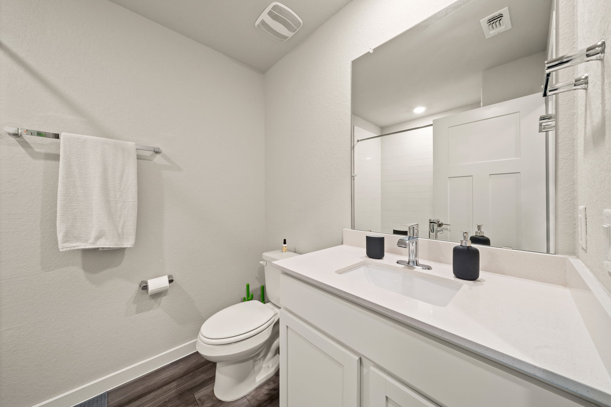 1117 Tipton Street Georgetown, TX 78633 - Photo 29 of 40 Bathroom featuring a white vanity with a rectangular undermount sink, a large mirror, and wood-finish flooring