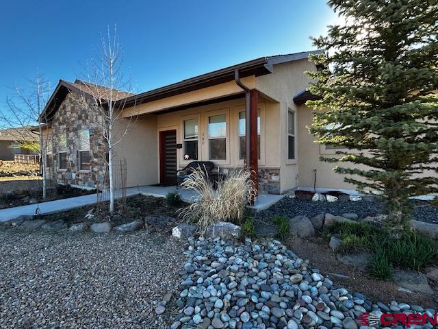 300 Southeast Sandstone Court Cedaredge, CO 81413 - Photo 1 of 38 a front view of a house with garden