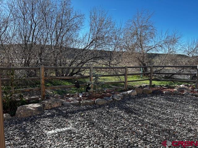 300 Southeast Sandstone Court Cedaredge, CO 81413 - Photo 13 of 38 a view of a yard with a tree