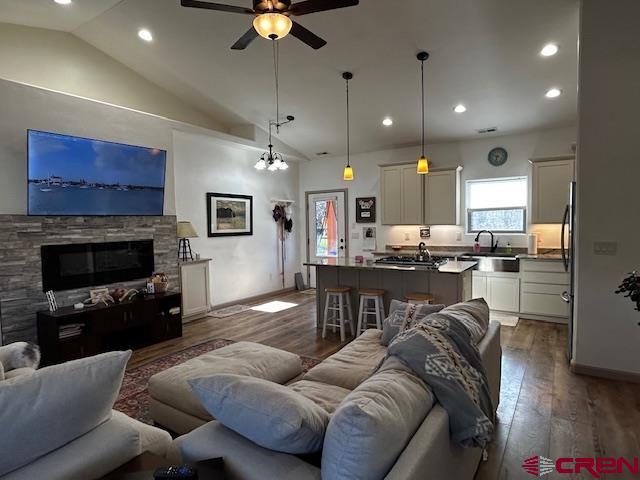 300 Southeast Sandstone Court Cedaredge, CO 81413 - Photo 17 of 38 a living room with furniture kitchen view and a fireplace