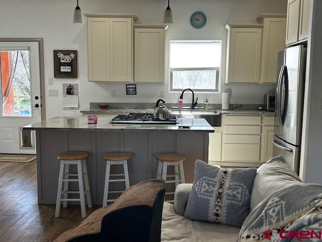 300 Southeast Sandstone Court Cedaredge, CO 81413 - Photo 19 of 38 a kitchen with stainless steel appliances granite countertop a sink a stove a refrigerator cabinets and a window