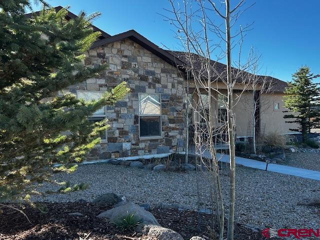 300 Southeast Sandstone Court Cedaredge, CO 81413 - Photo 2 of 38 a view of a house with a yard and sitting area