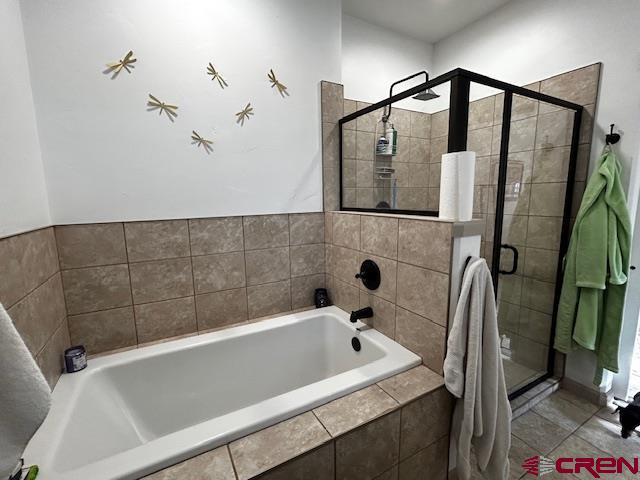 300 Southeast Sandstone Court Cedaredge, CO 81413 - Photo 25 of 38 a bathroom with a bathtub and a shower