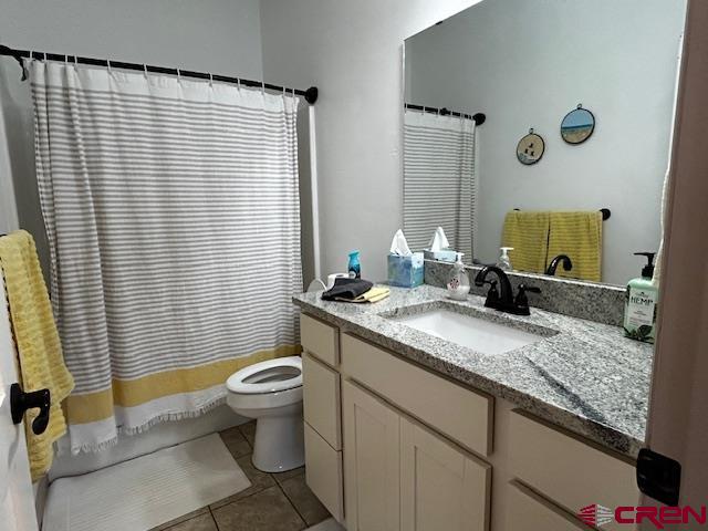 300 Southeast Sandstone Court Cedaredge, CO 81413 - Photo 28 of 38 a bathroom with a granite countertop sink a toilet and mirror