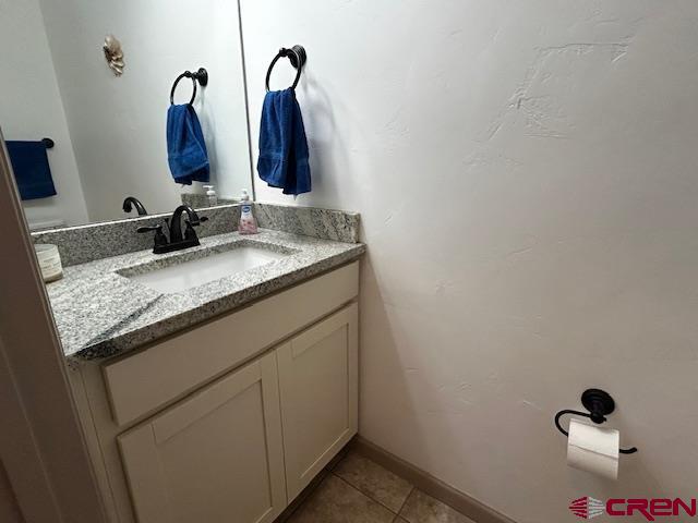 300 Southeast Sandstone Court Cedaredge, CO 81413 - Photo 29 of 38 a bathroom with a granite countertop sink and a mirror