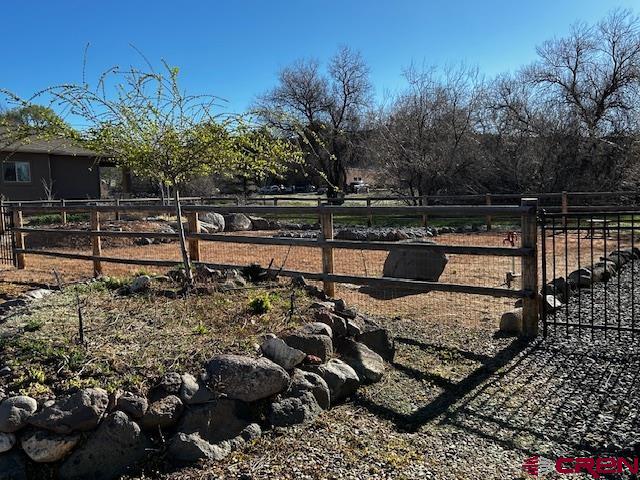 300 Southeast Sandstone Court Cedaredge, CO 81413 - Photo 10 of 38 a view of a yard with plants and sitting area