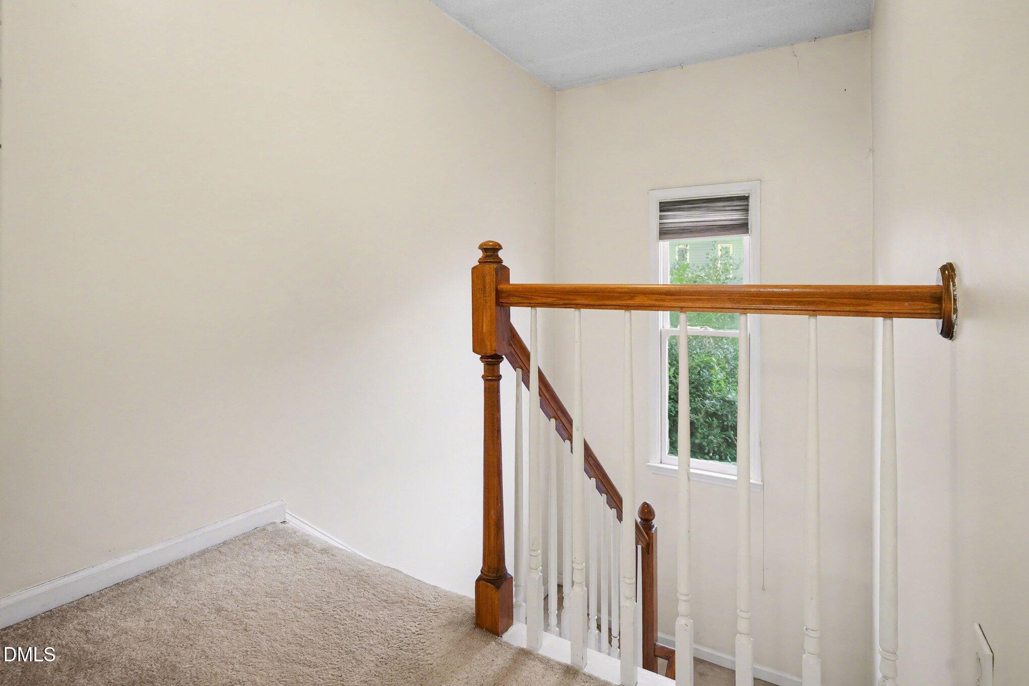 1502 Oakland Hills Way Raleigh, NC 27604 - Photo 14 of 26 a view of staircase with railing and white walls