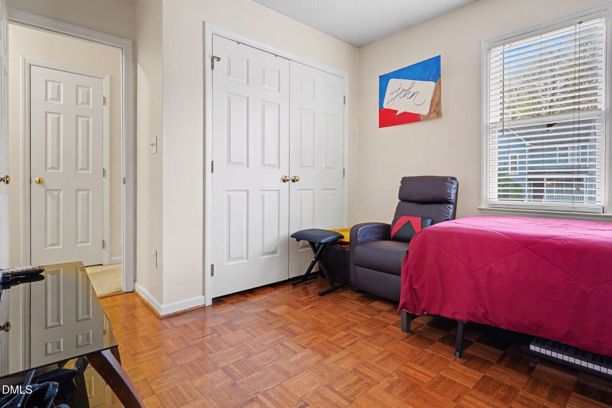 1502 Oakland Hills Way Raleigh, NC 27604 - Photo 18 of 26 a bed room with a bed and a chair