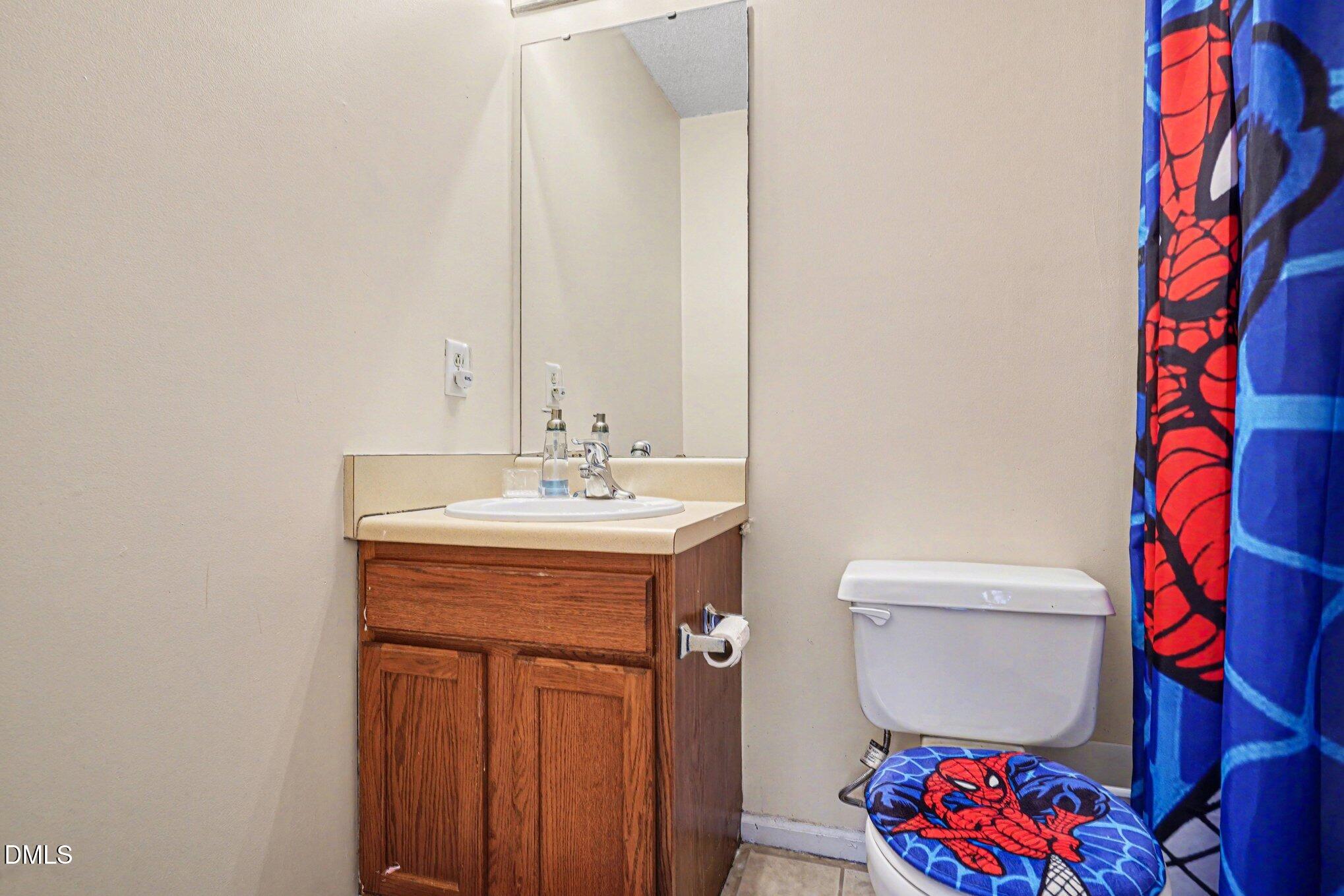 1502 Oakland Hills Way Raleigh, NC 27604 - Photo 19 of 26 a bathroom with a sink and a mirror
