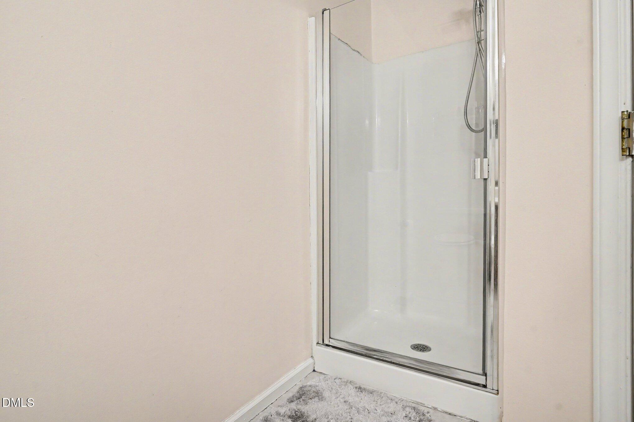 1502 Oakland Hills Way Raleigh, NC 27604 - Photo 22 of 26 a bathroom with a glass shower door