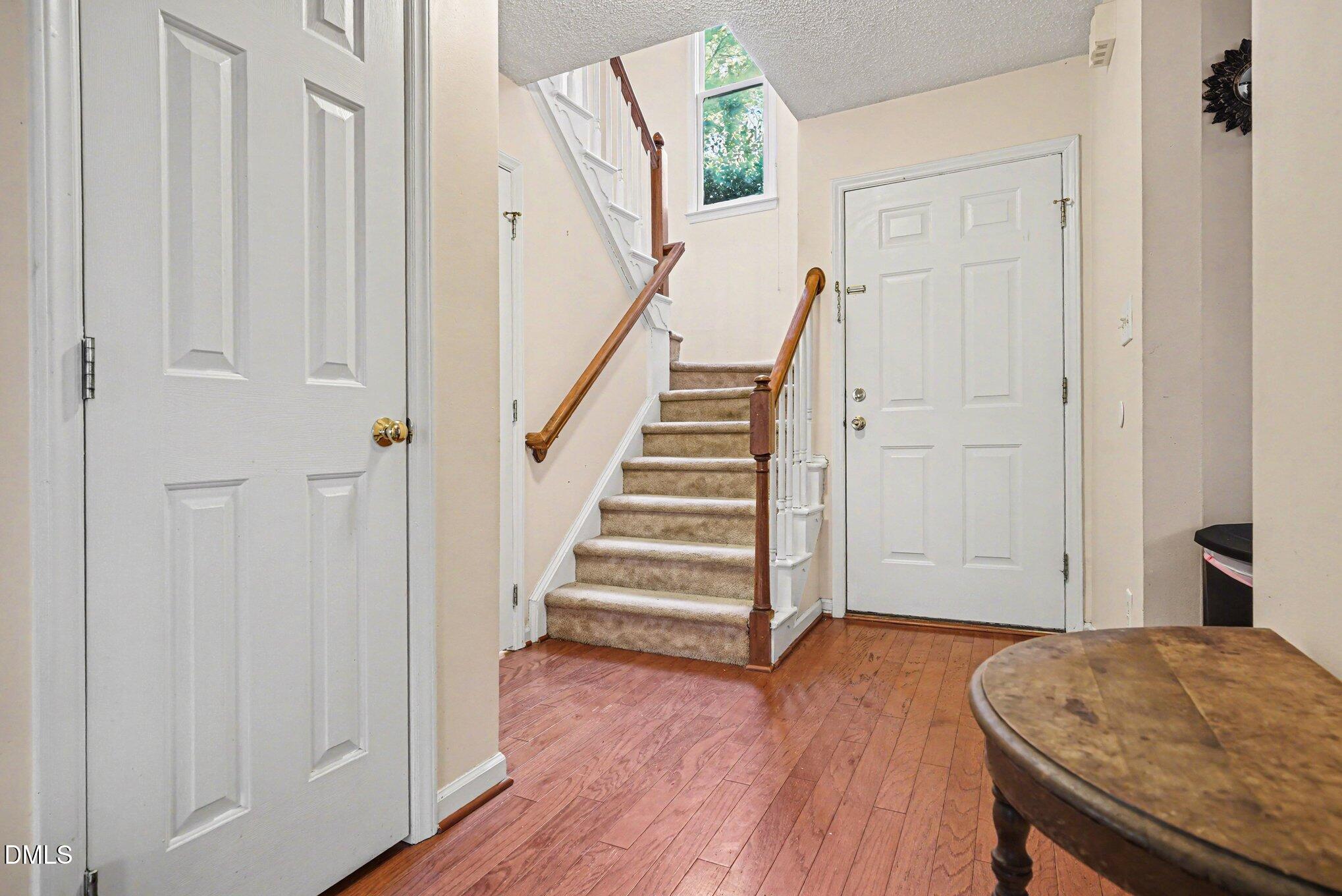 1502 Oakland Hills Way Raleigh, NC 27604 - Photo 5 of 26 a view of a hallway with wooden floor and entryway