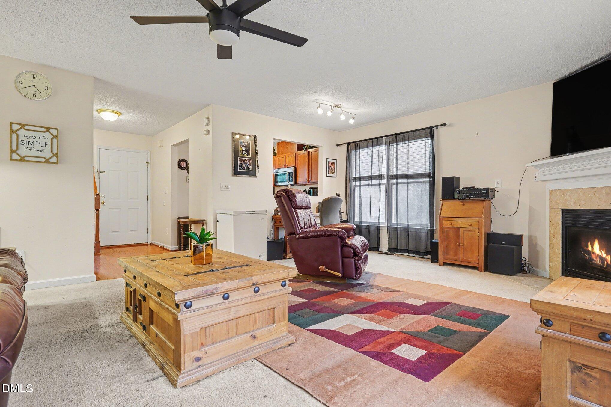 1502 Oakland Hills Way Raleigh, NC 27604 - Photo 7 of 26 a bed room with furniture and a flat screen tv