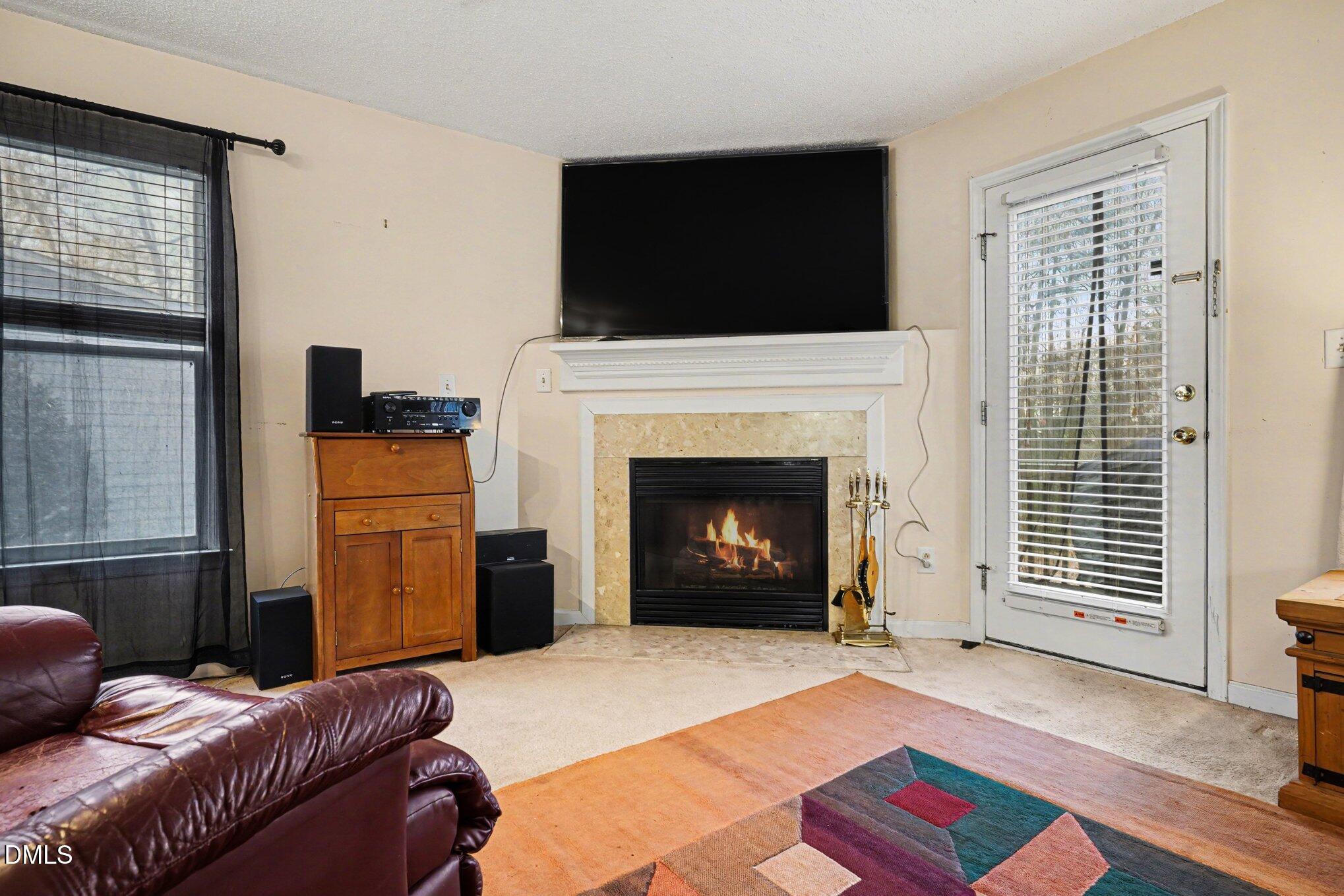 1502 Oakland Hills Way Raleigh, NC 27604 - Photo 9 of 26 a living room with furniture and a fireplace