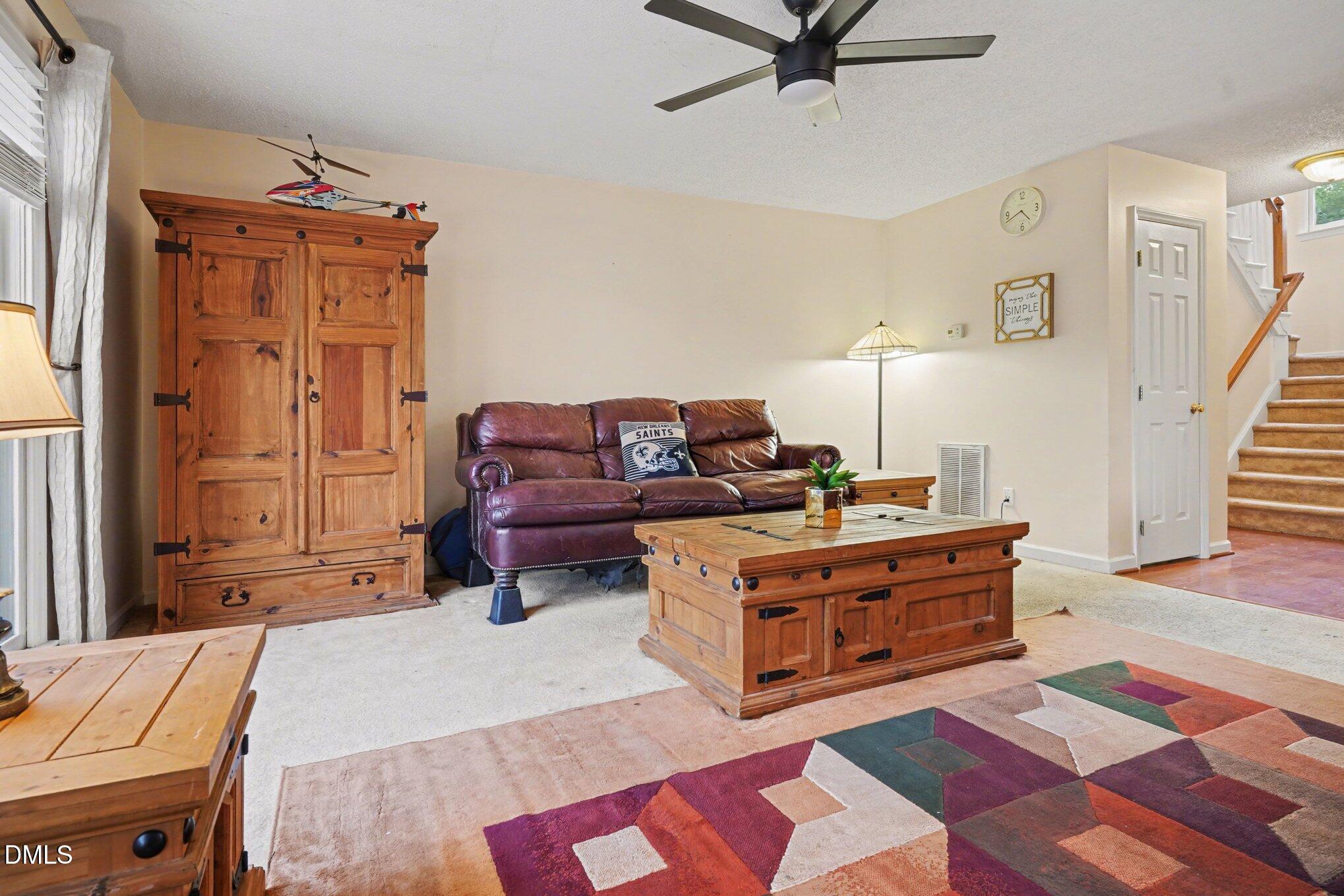 1502 Oakland Hills Way Raleigh, NC 27604 - Photo 10 of 26 a living room with furniture and a wooden floor