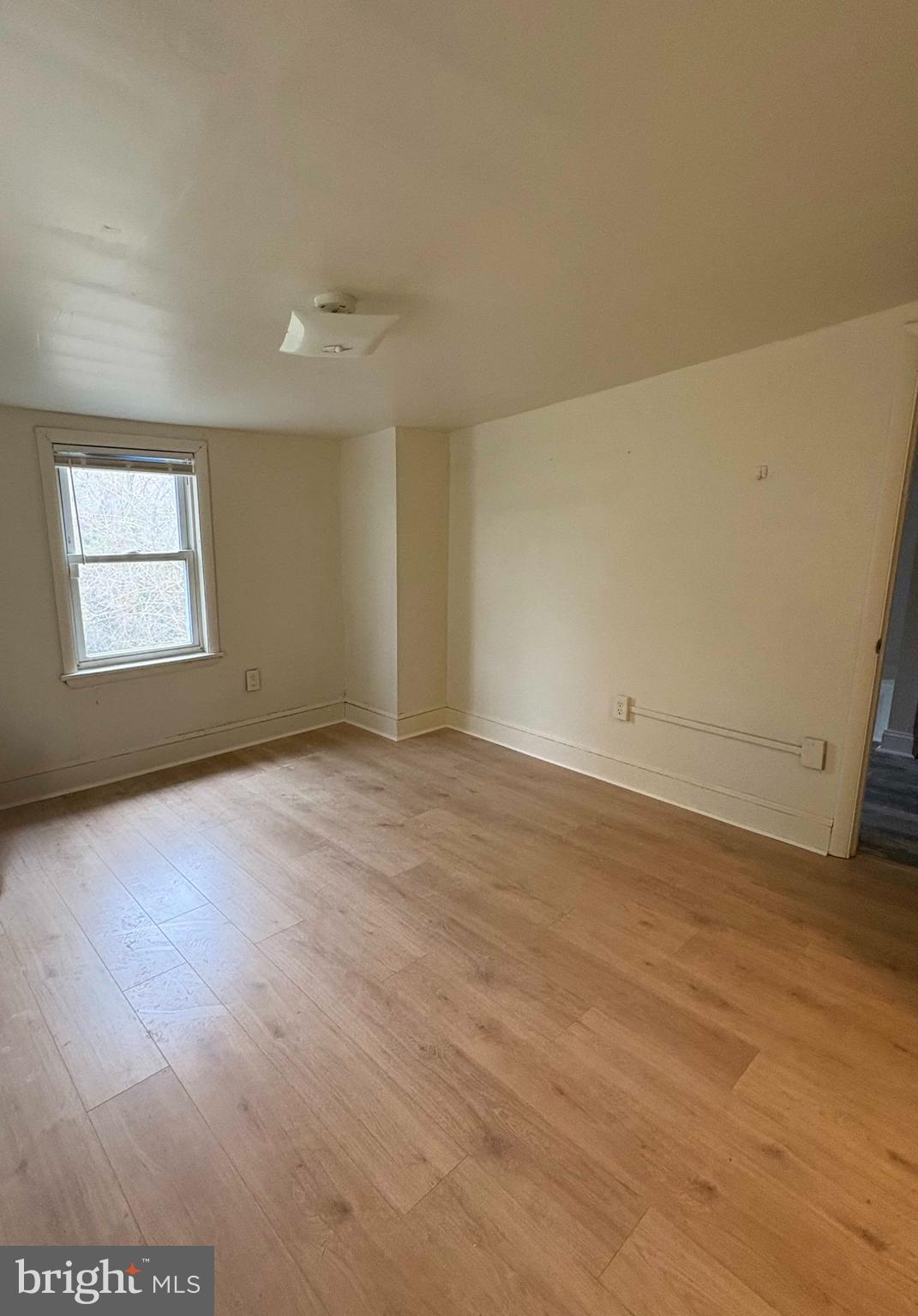 210 Wesley Street Salem, NJ 08079 - Photo 11 of 17 an empty room with wooden floor and windows
