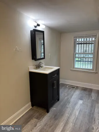 a bathroom with a sink vanity and mirror