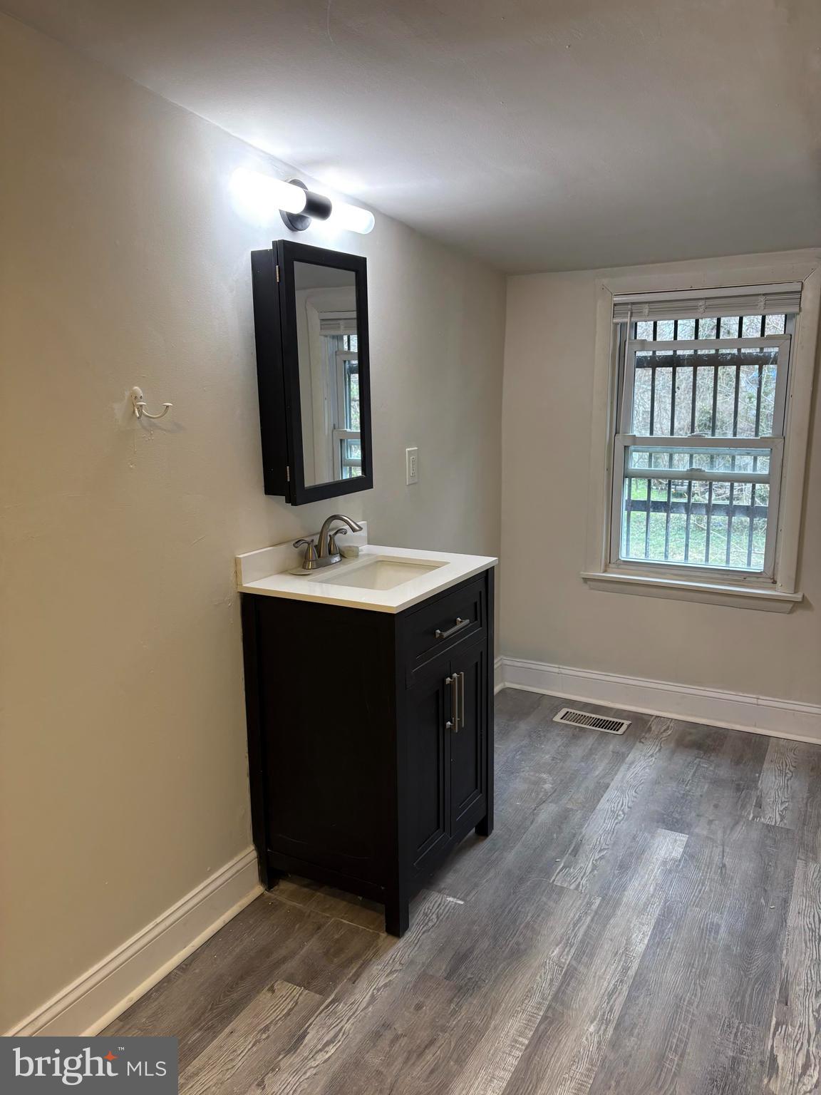 210 Wesley Street Salem, NJ 08079 - Photo 12 of 17 a bathroom with a sink vanity and mirror