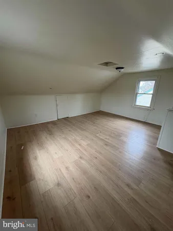 an empty room with wooden floor