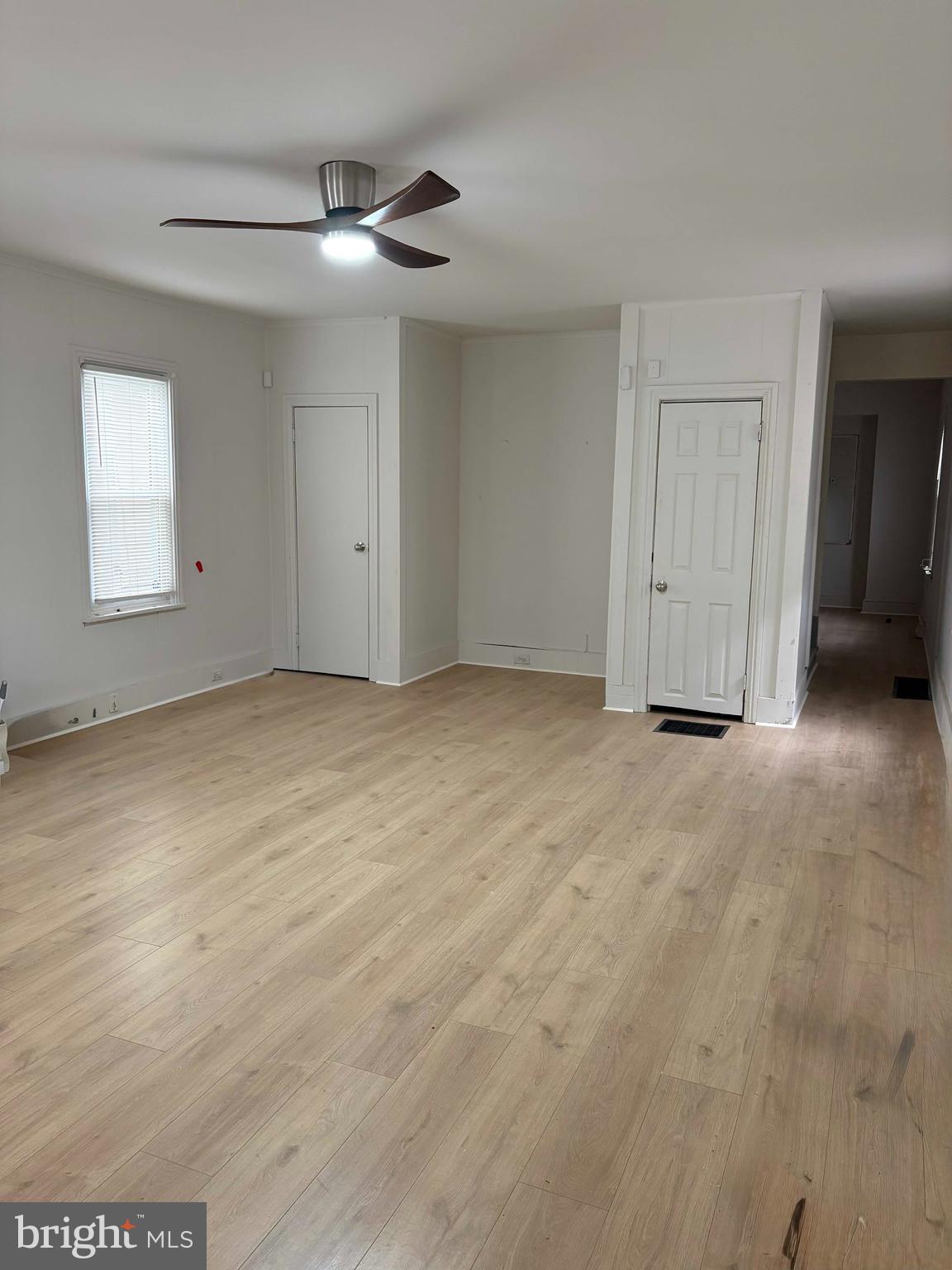 210 Wesley Street Salem, NJ 08079 - Photo 2 of 17 an empty room with a ceiling fan and window