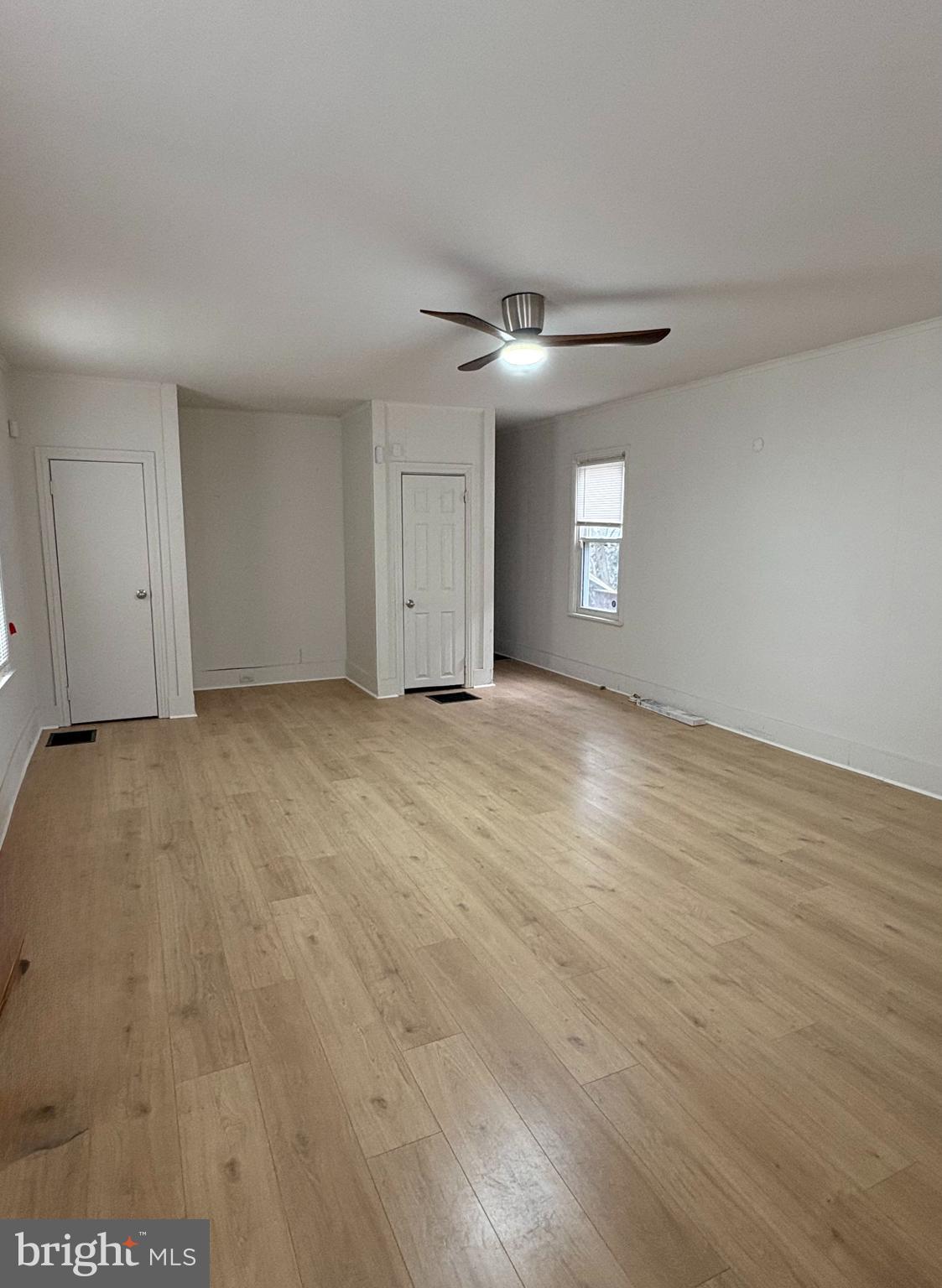 210 Wesley Street Salem, NJ 08079 - Photo 3 of 17 a view of an empty room with window and wooden floor