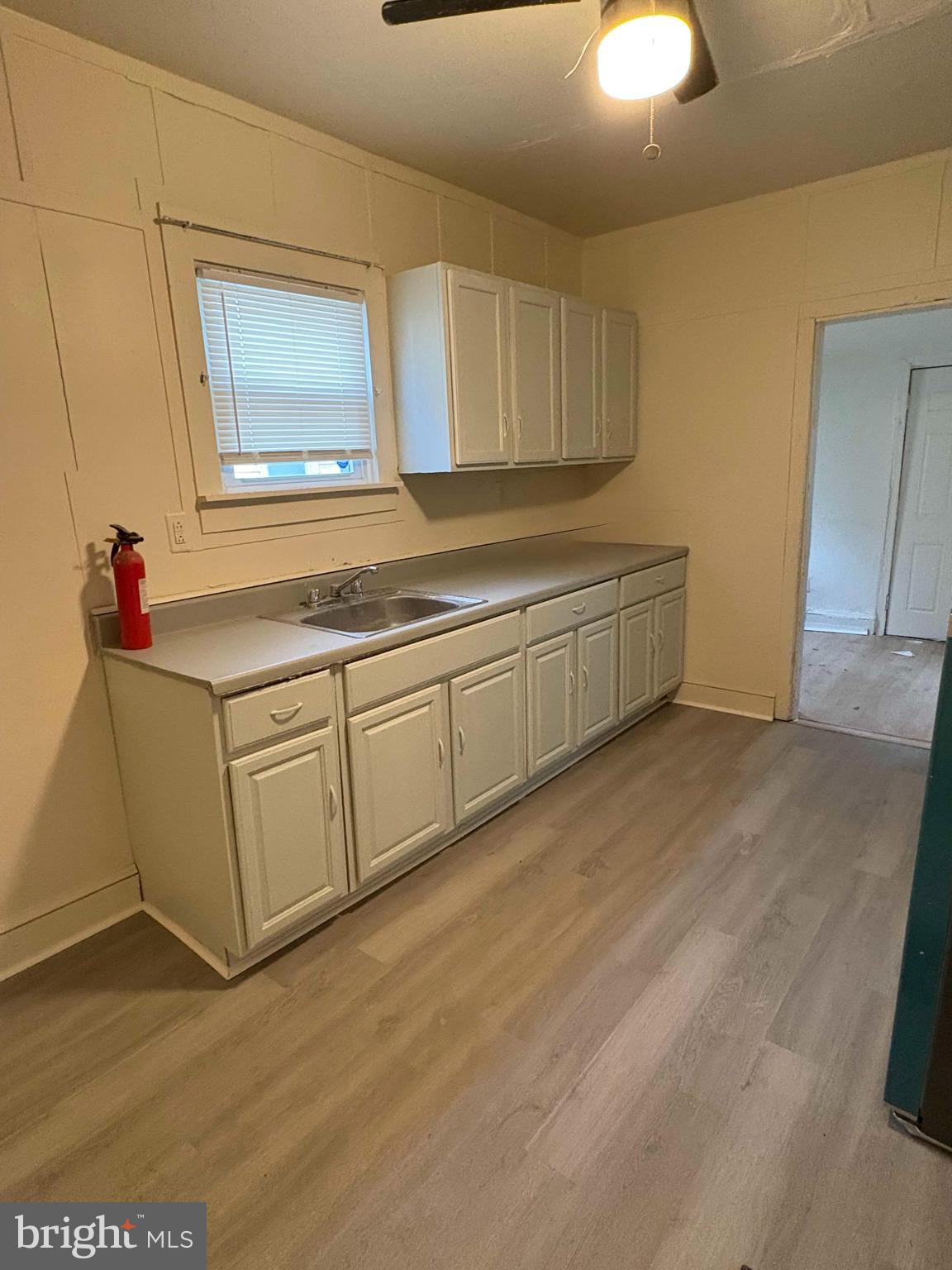 210 Wesley Street Salem, NJ 08079 - Photo 5 of 17 a room with cabinets and wooden floor