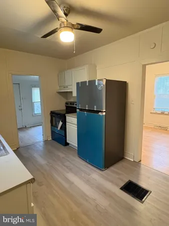 a kitchen with stainless steel appliances a refrigerator and a stove top oven