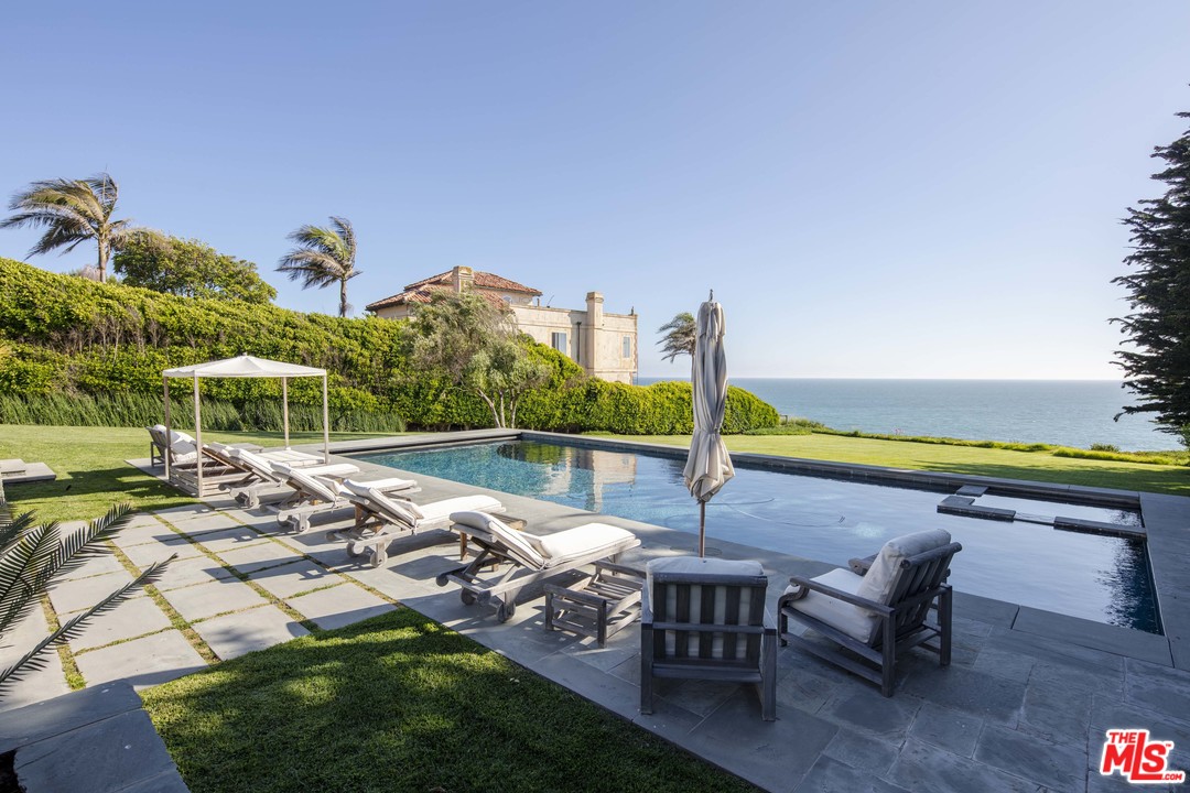 7163 Birdview Avenue Malibu, CA 90265 - Photo 2 of 22 a view of swimming pool with outdoor seating and plants