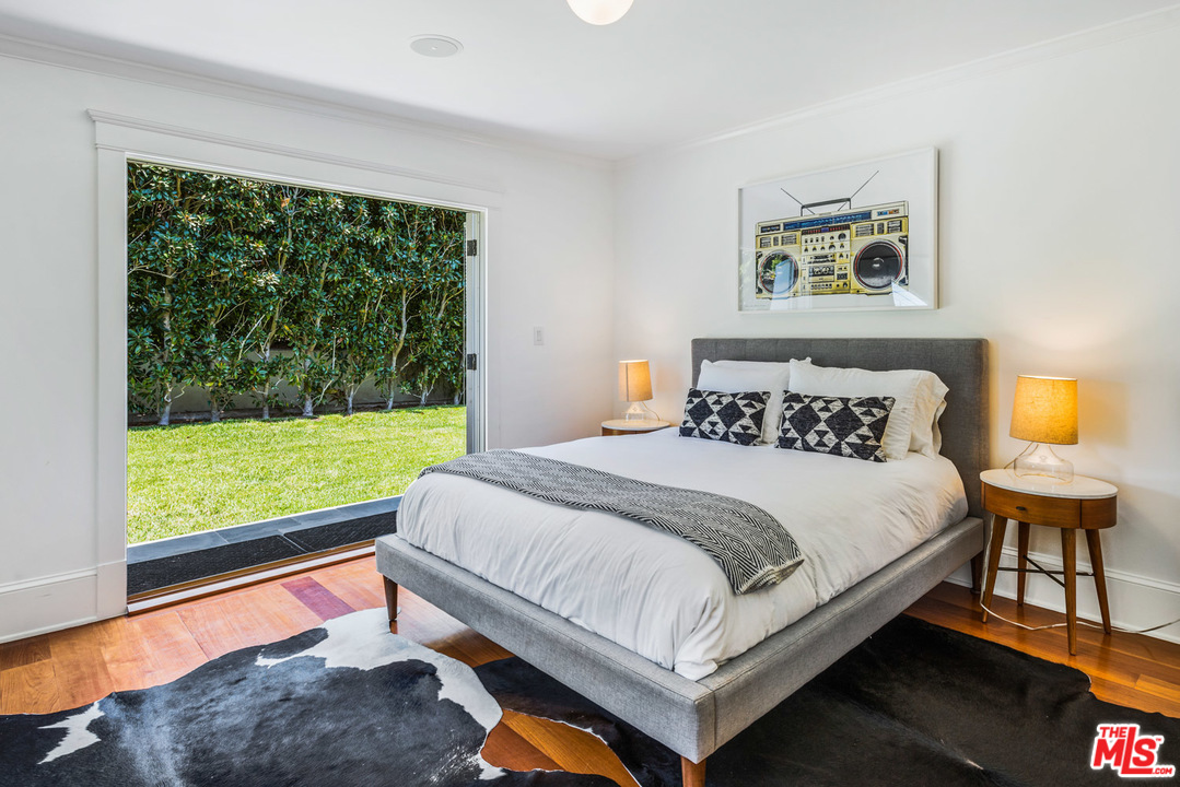 7163 Birdview Avenue Malibu, CA 90265 - Photo 12 of 22 a bedroom with a bed and a large window