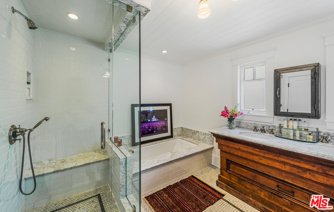 7163 Birdview Avenue Malibu, CA 90265 - Photo 13 of 22 a bathroom with a double vanity sink mirror and shower