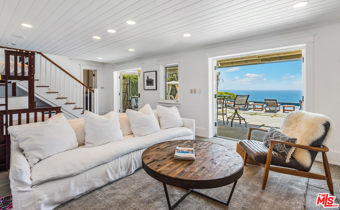 7163 Birdview Avenue Malibu, CA 90265 - Photo 17 of 22 a living room with furniture and a rug