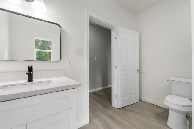 a white toilet sitting next to a bath tub