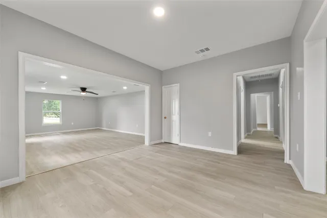 a kitchen with a sink a stove cabinets and a window