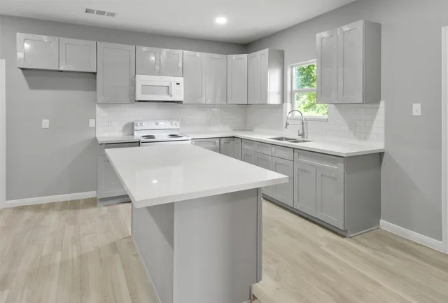 a kitchen with a sink cabinets and window