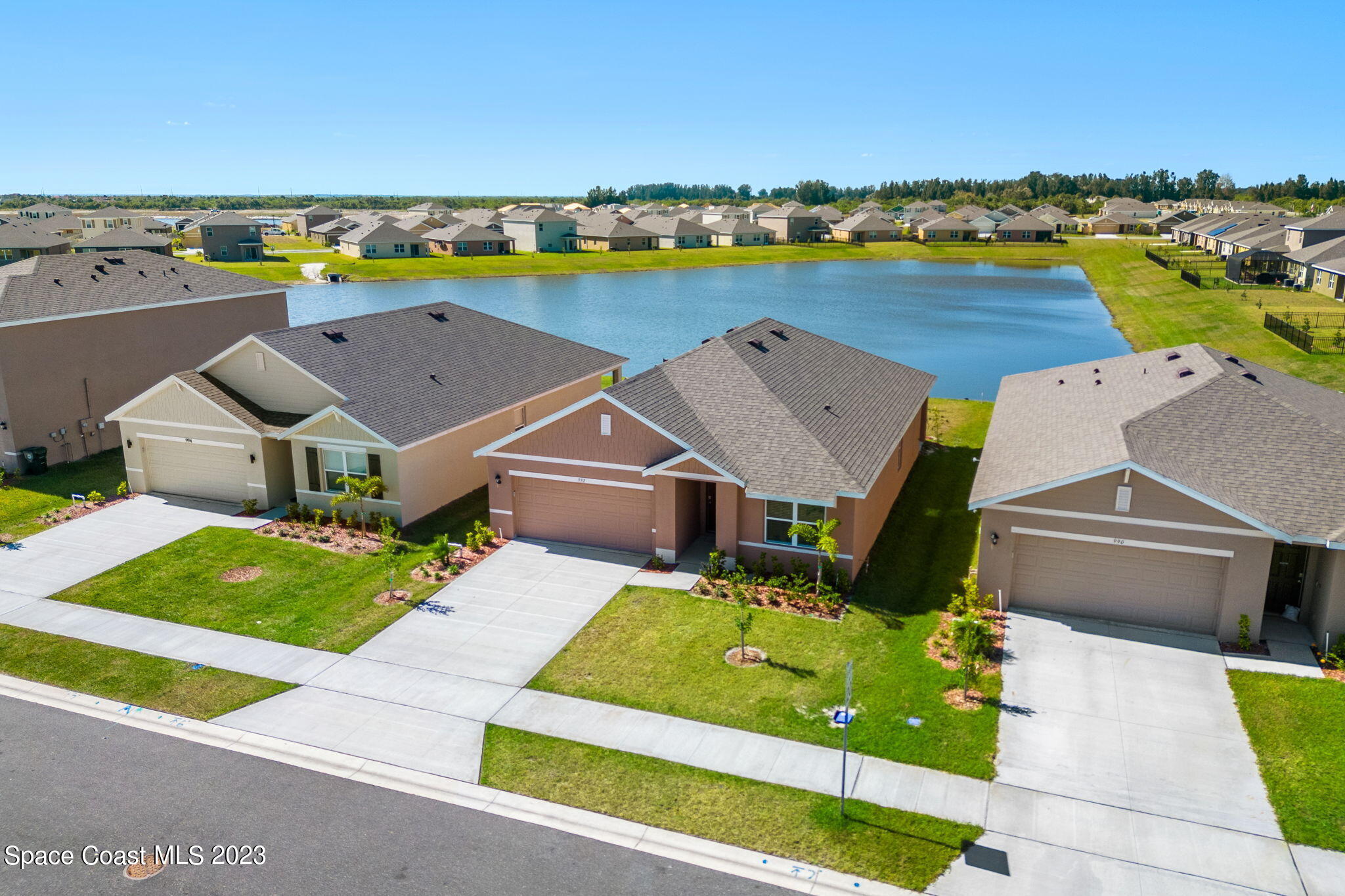 992 Trinity Street Rockledge, FL 32955 - Photo 14 of 19 an aerial view of a house with a big yard and large trees