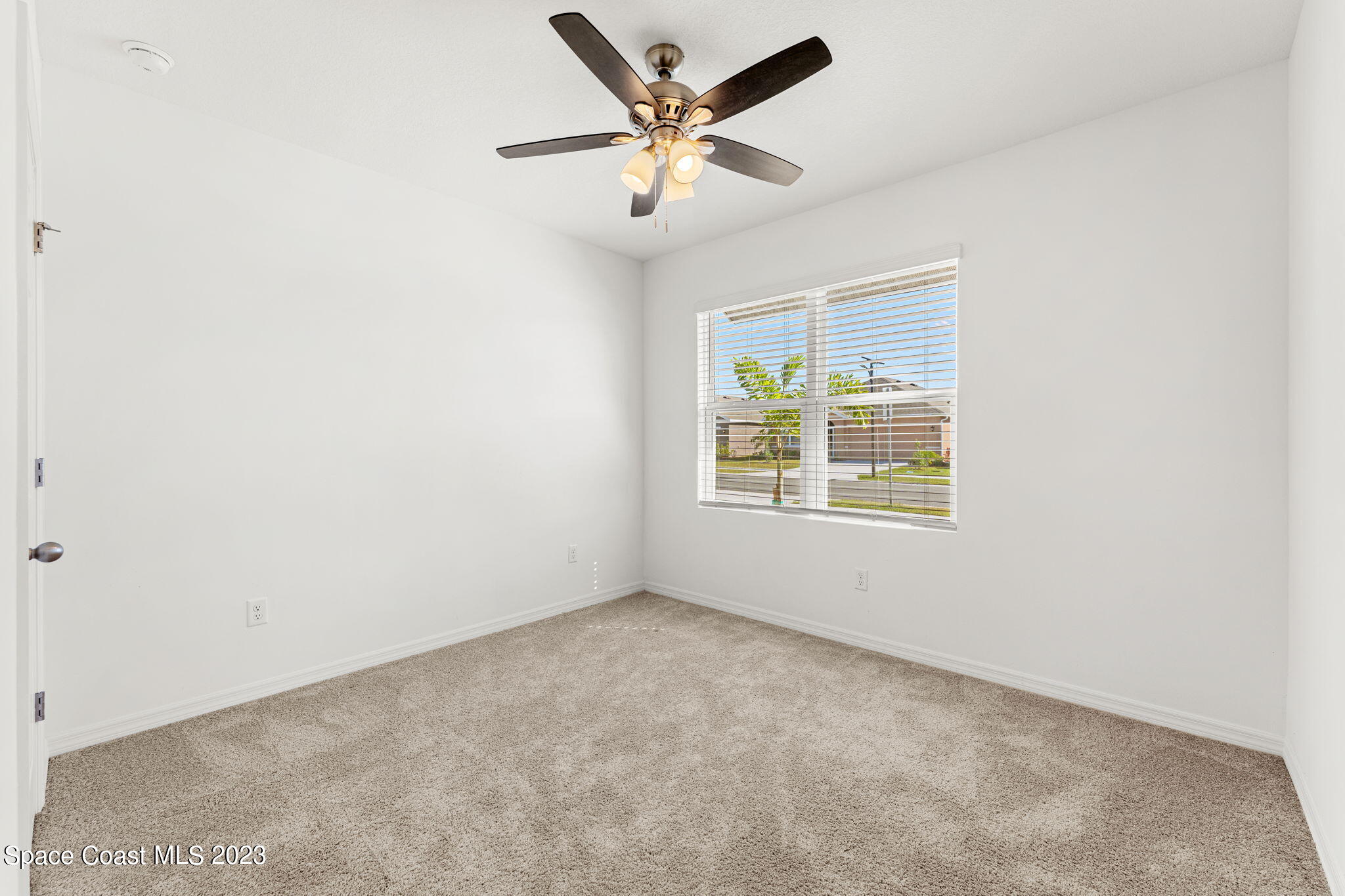 992 Trinity Street Rockledge, FL 32955 - Photo 7 of 19 an empty room with a window and a ceiling fan