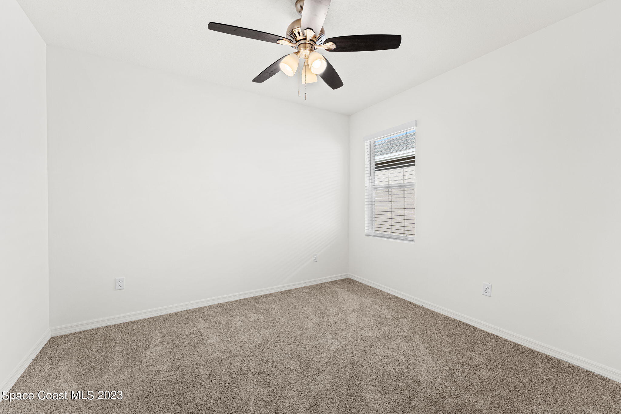 992 Trinity Street Rockledge, FL 32955 - Photo 9 of 19 an empty room with a window and a fan