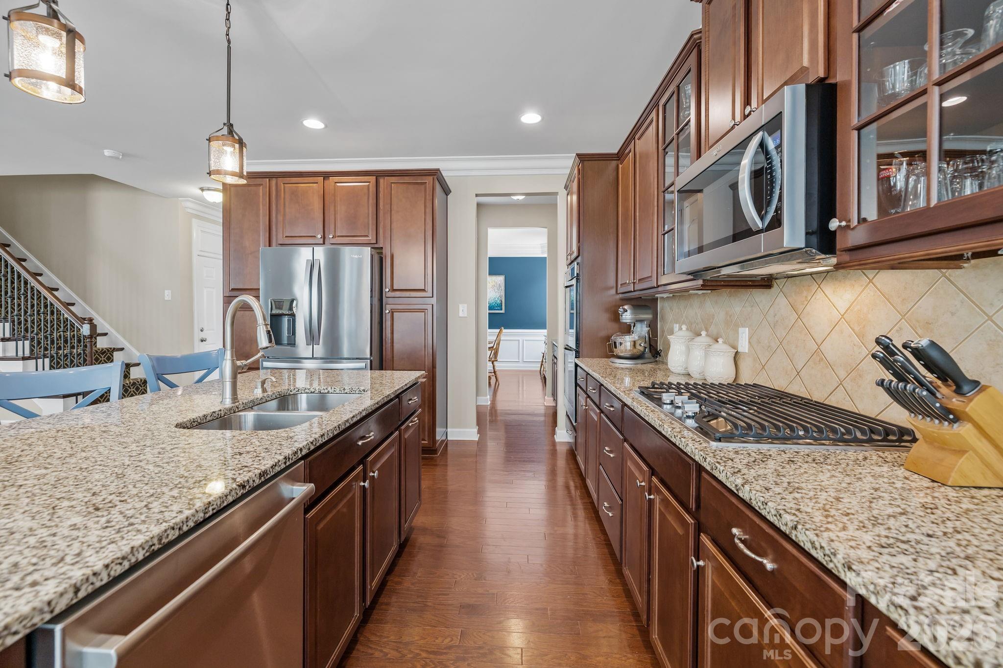 2072 Clarion Drive Fort Mill, SC 29707 - Photo 12 of 47 a kitchen with stainless steel appliances granite countertop a sink a stove and a wooden floors