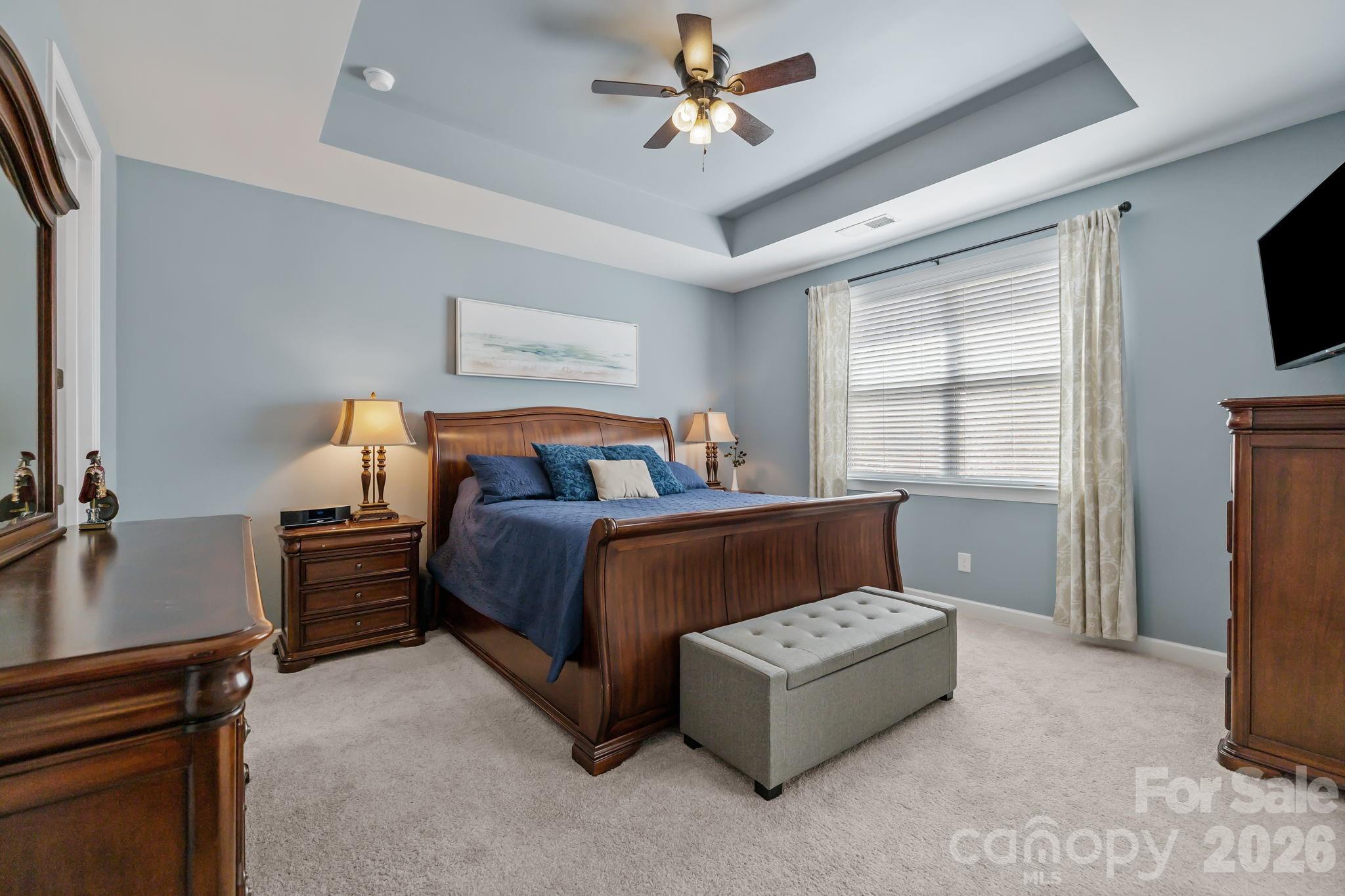 2072 Clarion Drive Fort Mill, SC 29707 - Photo 28 of 47 a bedroom with a large bed and a flat tv screen on dresser
